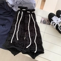 Black knit leg warmers with white drawstrings and hollow-out design for women - One Size / Black