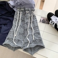 Grey knit leg warmers with star cutouts and white drawstring ties in flat lay - One Size / Gray