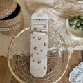 Beige mid-calf socks with red floral pattern in a rustic lifestyle setting - One Size / All-over Floral