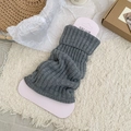 Grey ribbed knit leg warmers with folded cuff in a cozy minimalist home setting - Gray