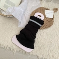 Striped black knitted leg warmers with gray bands in a cozy college style setting - Black