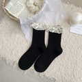 Black mid-calf socks with white lace trim and bow detail on soft white plush background - One Size / Black