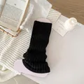 Classic black knitted leg warmer with vertical rib texture for a slim, stylish look - Black