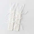 White knit leg warmers with delicate lace trim and satin bow accents for a Lolita style - White