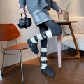 Knitted leg warmers for women featuring snowflake patterns and warm ribbed cuffs - One Size / White