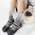 Grey knit mid-calf socks with white lace ruffles and pearls styled with black shoes - Gray