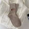 Brown knit socks with 'MY CAT' embroidery and fluffy pom-poms on a cozy background - One Size / Light Coffee