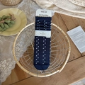 Dark blue knit crew socks with white polka dots and lace-trim texture in a cozy setting - One Size / Navy Blue