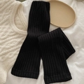 Classic black ribbed knit leg warmers in a soft elastic fabric for winter fashion - Black