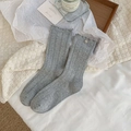 Light gray knit socks with wavy ruffle trim and a decorative silver metal buckle - One Size / Gray