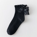 Chaussettes hautes Lolita noires avec grand nœud en résille et bordure à volants - Taille unique / Noir