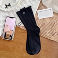Elegant black mid-calf ribbed socks with ruffled edges and small silver button detail - One Size / Black
