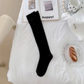 Classic black knee-high stockings in a soft knitted fabric for a minimalist student style - Black