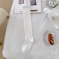 Classic white calf-length socks in cotton knit, featured on a cozy aesthetic background - White