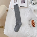 Japanese style grey knee-high knit socks in a cozy morning aesthetic setting - Gray