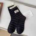 Japanese style black and white striped socks with yellow rolled edges and fabric label - One Size / Black