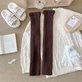 Deep brown ribbed knit leg warmers in a cozy winter setting with warm textures - One Size / Coffee
