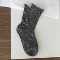Dark grey crew socks featuring white bow patterns and stylish rolled edge cuffs - One Size / Medium Grey