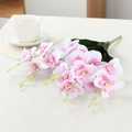 Artificial white orchid stem with pink centers and green leaves on a table - 5-Branch Phalaenopsis / White Purple