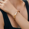 Minimalist 18K gold plated cuff bracelet with vintage hammered texture on model wrist - Narrow Hammered Style (KB0687-3)
