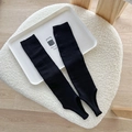 Long black ribbed knit leg warmers with stirrup design for a balletcore fashion style - Black