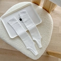White ribbed knit leg warmers with stirrup straps in a minimalist aesthetic style - Bleached White