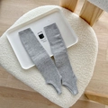 Grey vertical ribbed knitted stirrup leg warmers in a balletcore style for women - Gray