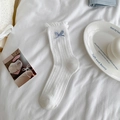 White frilly ruffle crew socks with a light blue bow accent and vertical ribbed texture - One Size / Bleached White