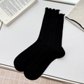 Minimalist black crew socks with ruffle trim and vertical ribbed knit texture - One Size / Black