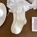 Creamy white knee-high socks with delicate lace trim and ribbon bows in ballet style - One Size / Beige