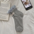 Gray mid-calf socks with blue checkered ruffle trim and white decorative label - Gray / One Size
