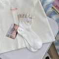 White crew socks with vertical ribbing and beige lace trim in a clean aesthetic flat lay - One Size / White