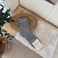 Grey ribbed knit socks with floral fabric bow detail and wood grain background - One Size / Gray