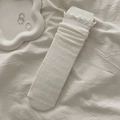 Off-white crew socks with knitted bow patterns and ruffled edges for a cute look - White