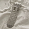 Light gray knit crew socks featuring bow jacquard patterns and ruffled wood ear edges - Gray
