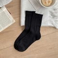 Black ribbed crew socks with stylish lettuce edge detail on wooden background - One Size / Black