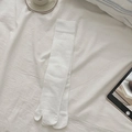 White ribbed Tabi socks with split-toe design for women in a cozy home setting - Bleached White
