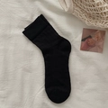 Ballet style black knit socks with delicate texture shown on minimalist white fabric - One Size / Black