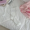 White pointelle knit crew socks with silk bow detail in a cozy aesthetic setting - One Size / White
