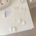 Creamy white sheer crew socks featuring heart mesh patterns and ribbed cuffs - White