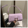 Detail of light purple leather handbag featuring a gold D-buckle and elegant knotted strap - Purple