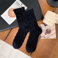 Sweet black crew socks with ruffled edges and textured knit on a cozy desktop - One Size / Black