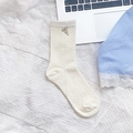Cream knit mid-calf socks featuring a metallic bow charm and classic cable pattern - Twist Knit Cream White (Metal Bow)