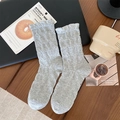 Light gray pleated mid-tube socks with wavy knit texture and ruffled cuffs in a flat lay - One Size / Gray