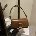 Elegant dark brown leather baguette bag with a gold D-ring buckle in a vintage chic style - Brown