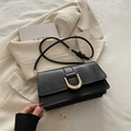 Minimalist black leather crossbody bag with golden buckle and knotted shoulder strap - Black
