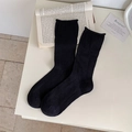 Classic black ribbed crew socks with wavy rolled edges on a minimalist aesthetic background - One Size / Black