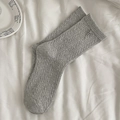 Grey cable-knit mid-calf socks with a silver bow charm pendant in minimalist style - One Size / Gray