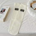 Japanese style white knee high lace socks with ruffled cuffs and black floral patches - One Size / White