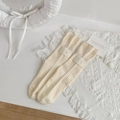 Cream knit mid-calf socks with vertical ribbing and a white Lucky patch decoration - One Size / Beige